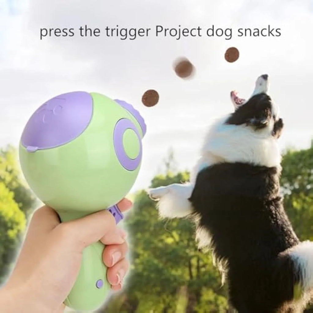 Green, orange, and pink plastic interactive dog treat launcher toy with remote feeding function.