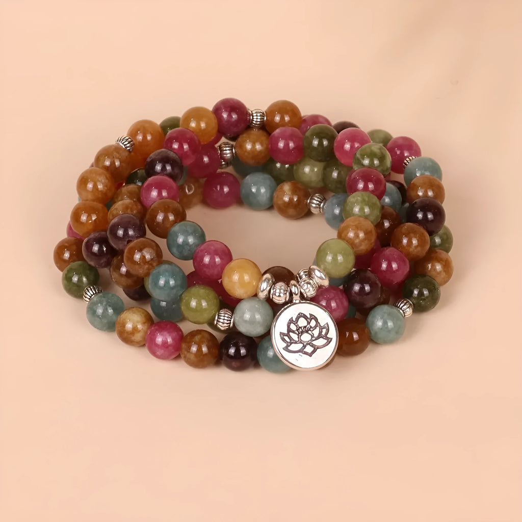 108-bead multi-layer lotus hanging bracelet in a tourmaline colour with alloy construction.