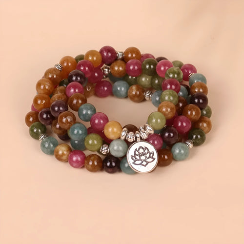 108-bead multi-layer lotus hanging bracelet in a tourmaline colour with alloy construction.