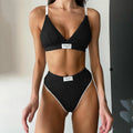 Grey women's bikini set with embroidery and contrast colour binding on a sleeveless top and shorts.
