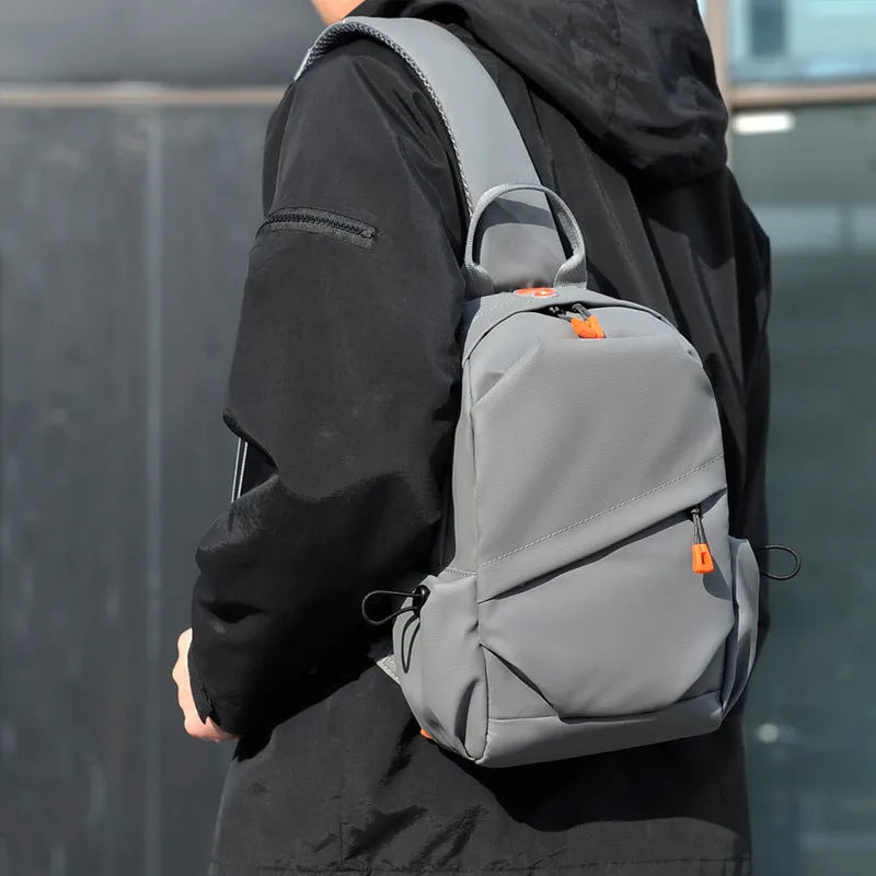 Men's black waterproof polyester crossbody bag worn across the body