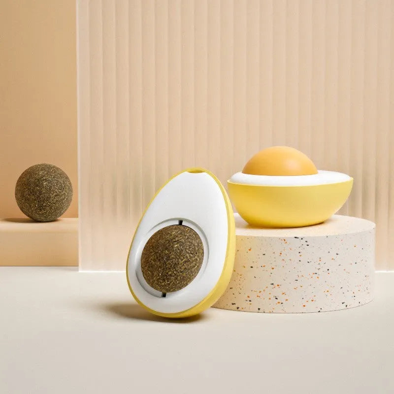 Interactive catnip ball toy with soft plush exterior mounted on wall for feline play