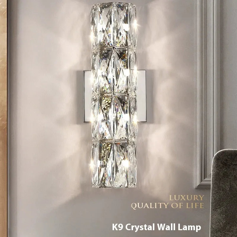 Modern crystal shade wall lamp in gold or chrome stainless steel, mounted on a wall.