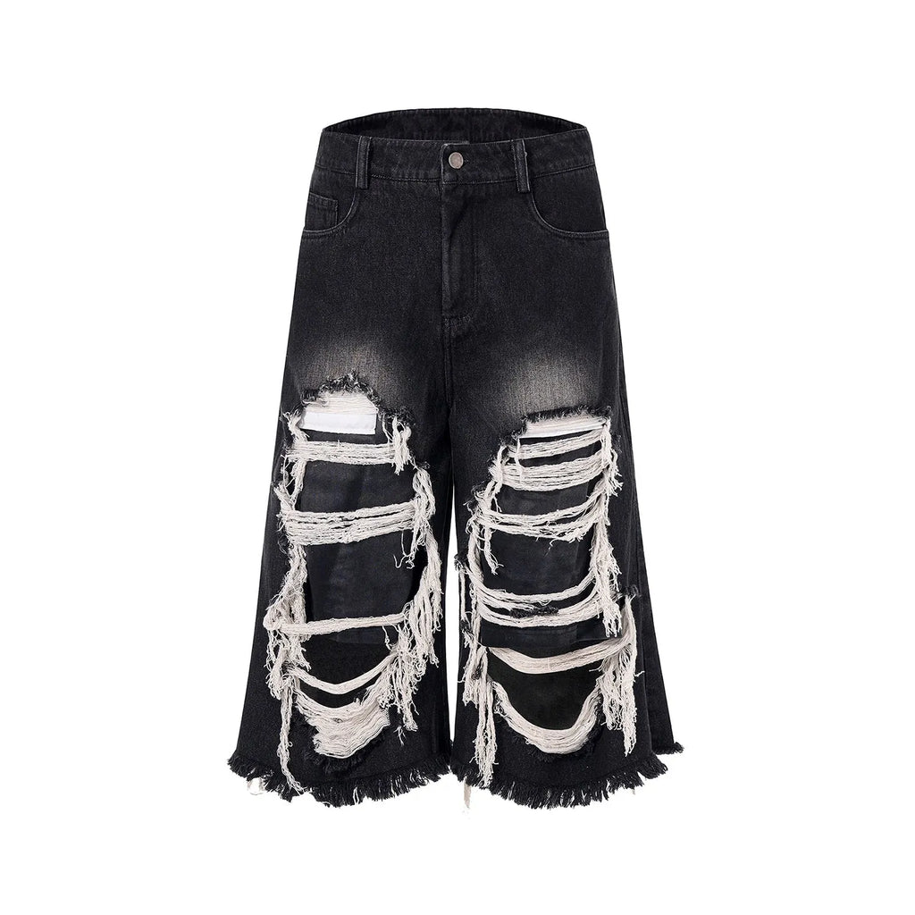 Black wide leg cropped jeans with mid-high waist and ripped patch detail on the legs.