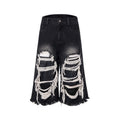 Black wide leg cropped jeans with mid-high waist and ripped patch detail on the legs.
