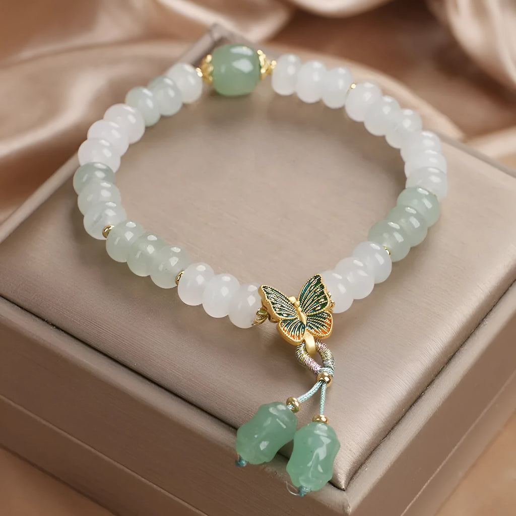 Green crystal women's bracelet with abacus beads, butterfly charm and tassel showing 17cm adjustable purity