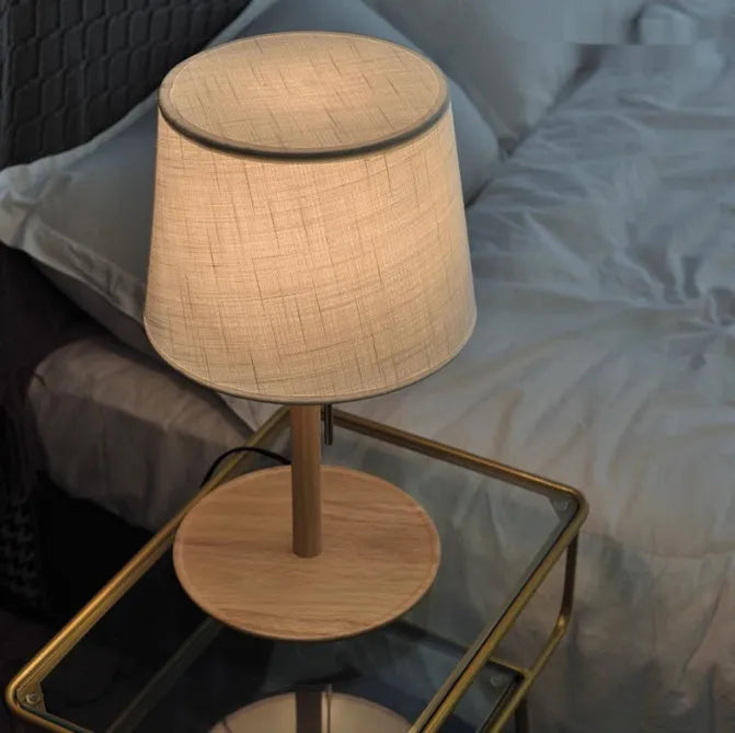 Walnut-colour solid wood bedside lamp with white cloth shade and cable switch