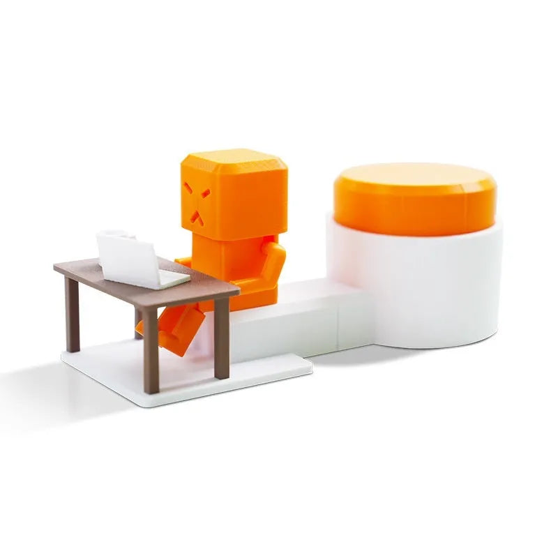 Orange plastic table turning decompression toy artefact on a flat surface.