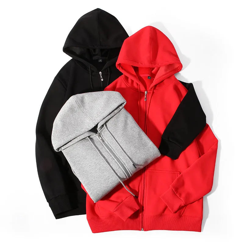 A plus size man wearing a heavy grey zip-up hooded cardigan sweater with side pockets.