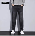 Men's straight leg casual jeans in black cotton denim with non-iron finish, side view.