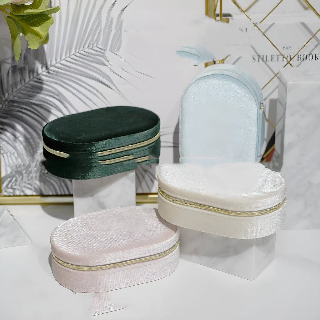 Oval velvet jewellery box in lake blue colour with flannel interior, shown with dimensions 15cm by 10cm.
