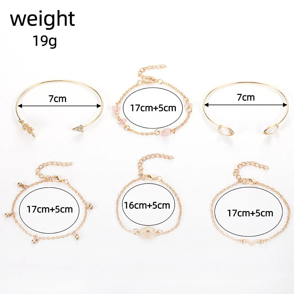 Set of six gold bracelets with arrow, V-shape, and water droplet charms on a dark background.