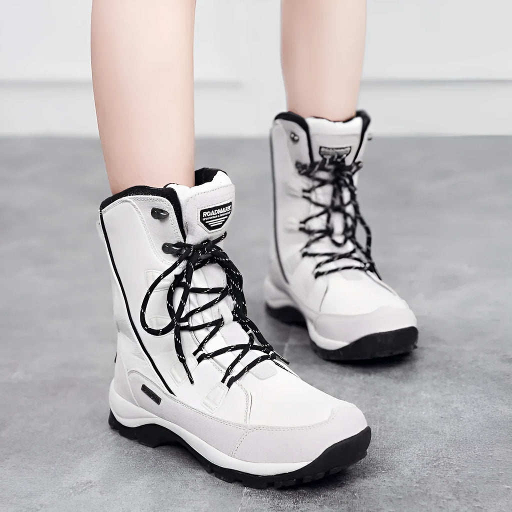 Women's black thermal snow boots with mid-calf height and round toe design