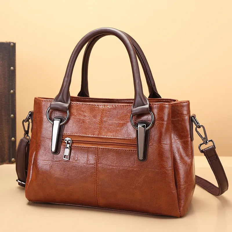 Horizontal square PU leather shoulder bag with contrasting stitching showing internal compartments including mobile phone section