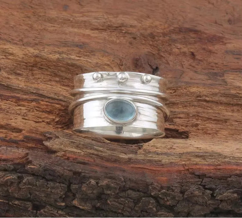 Handmade silver ring with natural aquamarine gemstone, retro geometric shape, on white background