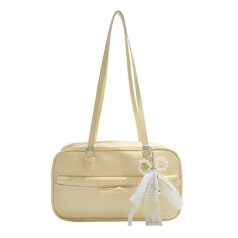 A horizontal square PU flap handbag in a solid colour with double-joint shoulder straps and optional pearl bow ornament.
