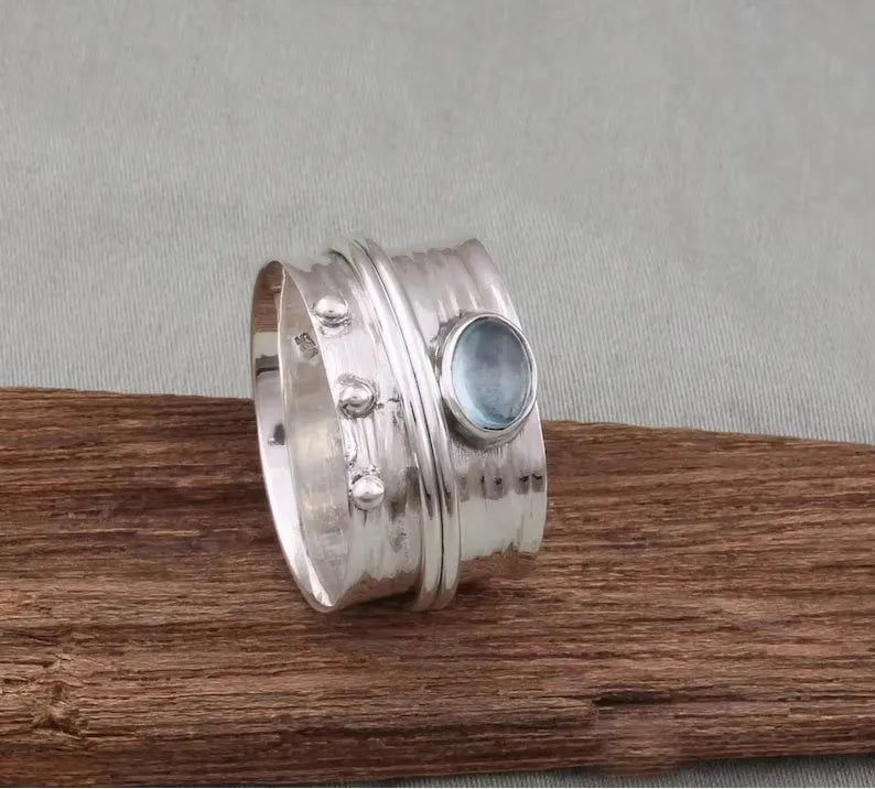 Handmade silver ring with natural aquamarine gemstone, retro geometric shape, on white background