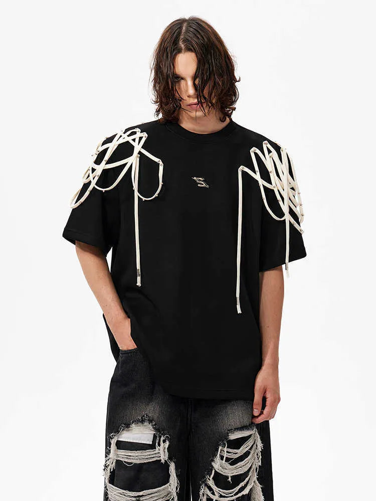 Black loose-fit short-sleeved t-shirt showing padded shoulder detail with rivet ribbon.