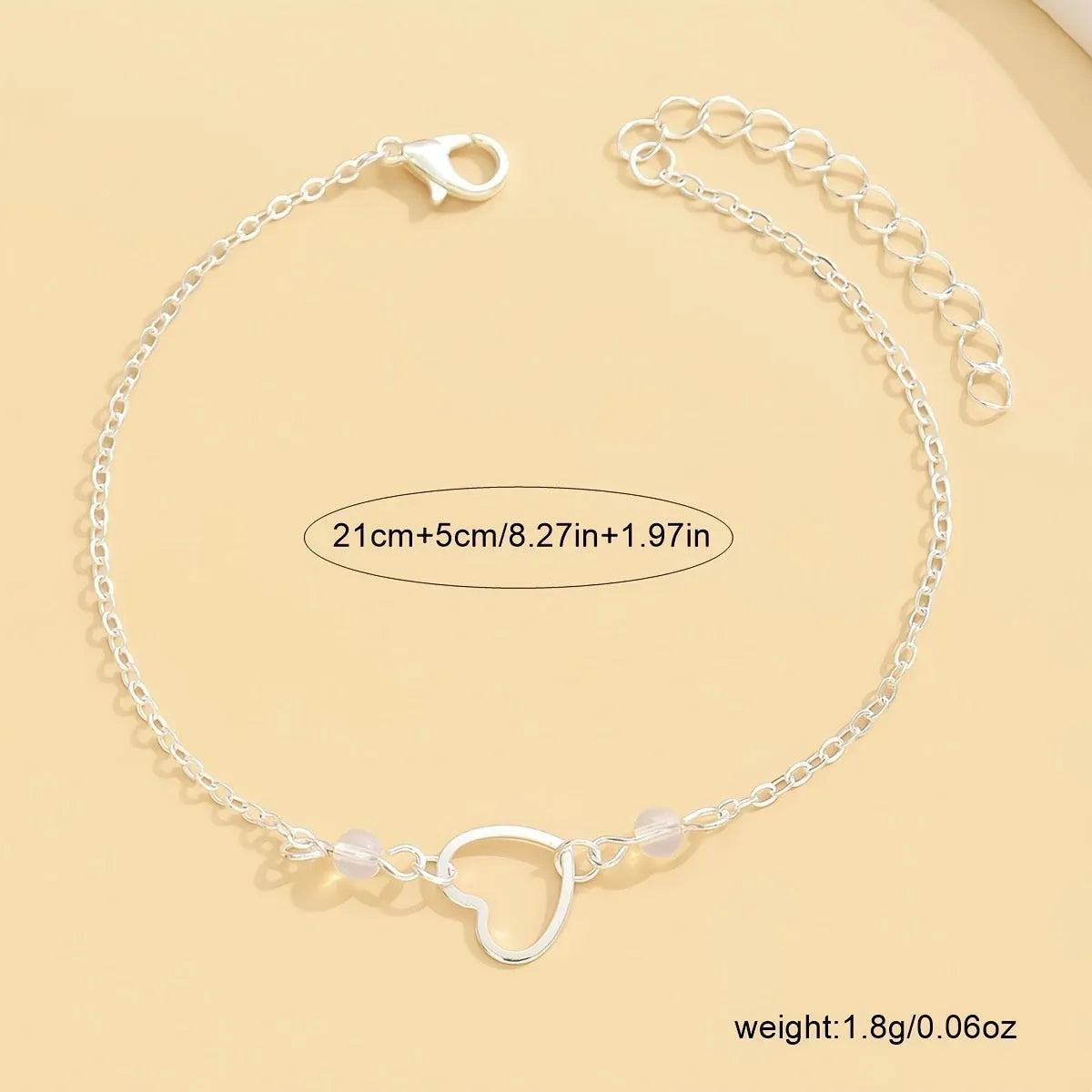 Adjustable women's anklet with heart-shaped pendant in gold and silver alloy metal