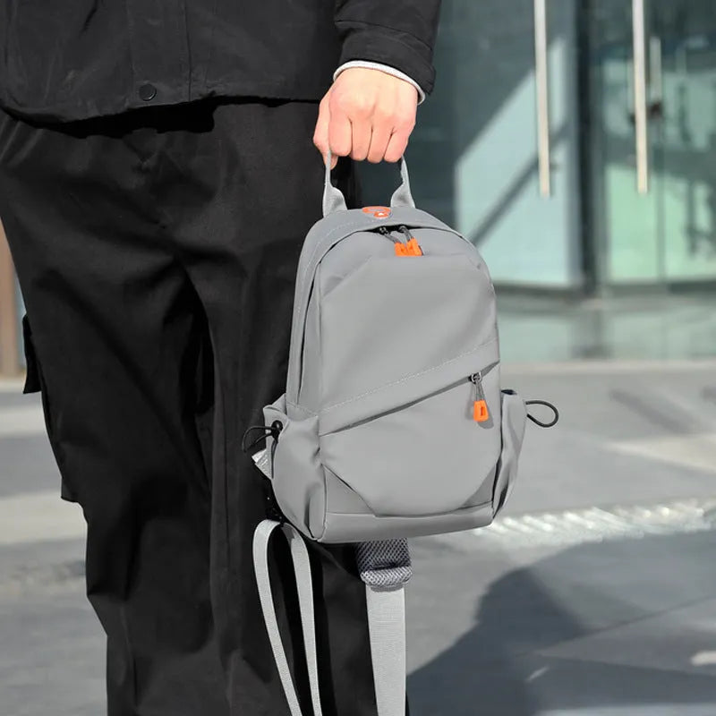 Men's black waterproof polyester crossbody bag worn across the body