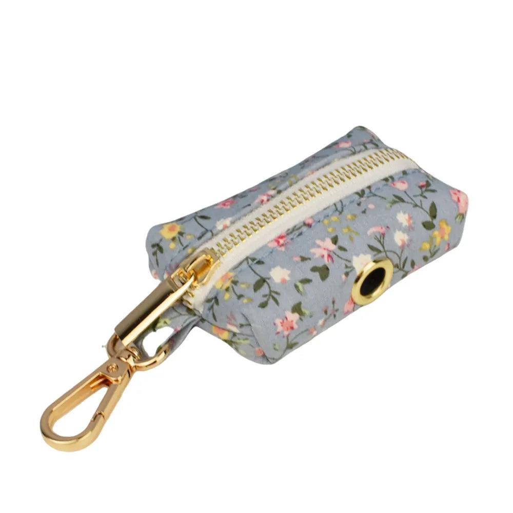 Blue floral polyester cotton dog collar set with matching leash, vest, poop bag, and decorative bow