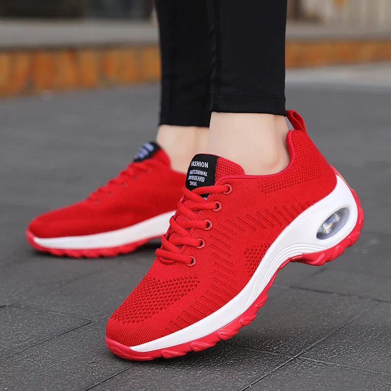 Women's black low top mesh sneakers with front laces and a round toe on a PU sole.