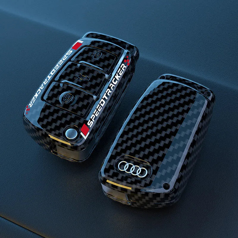 Carbon fibre style car key cover with a small mirror, shown in black and white colour options.