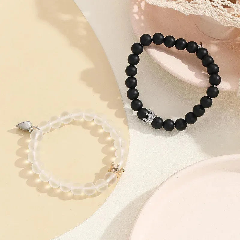 2pcs handmade glow-in-the-dark crown beaded bracelets in white and black with glass beads and luminous heart charm