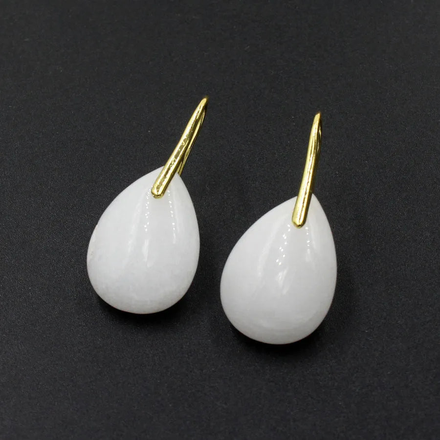 Geometric water drop crystal dangle earrings in multiple colour options on a plain background.