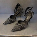 Women's black high heels with hollow stiletto heel, pointed toe, and a bright red sole.