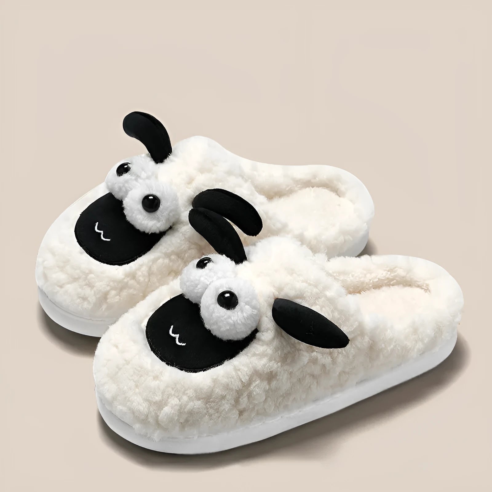 Brown, grey, and white suede slip-on slippers with a PVC sole on a plain background.