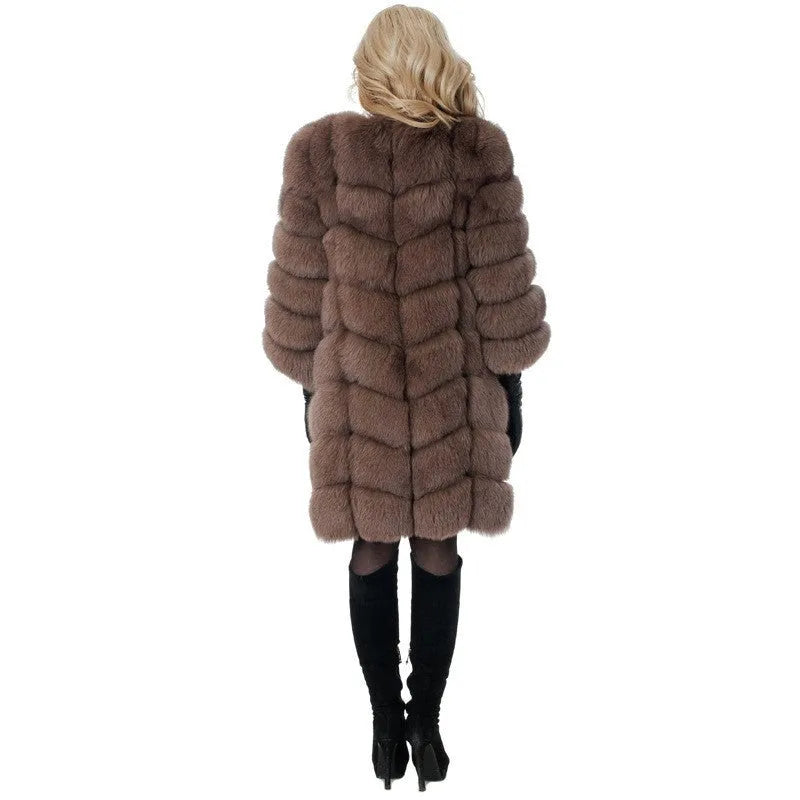 Women's thick black artificial fur coat with regular sleeves on a hanger.