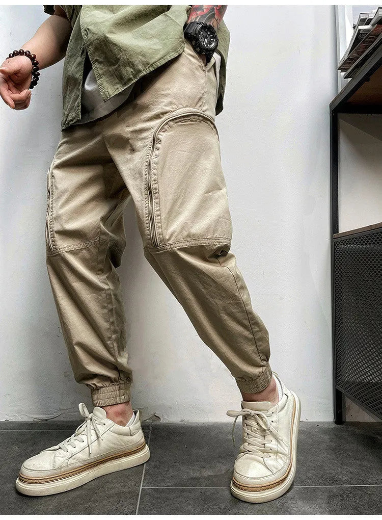 Men's elastic waist cotton cargo trousers with zippered pockets, loose fit, in khaki colour on plain background