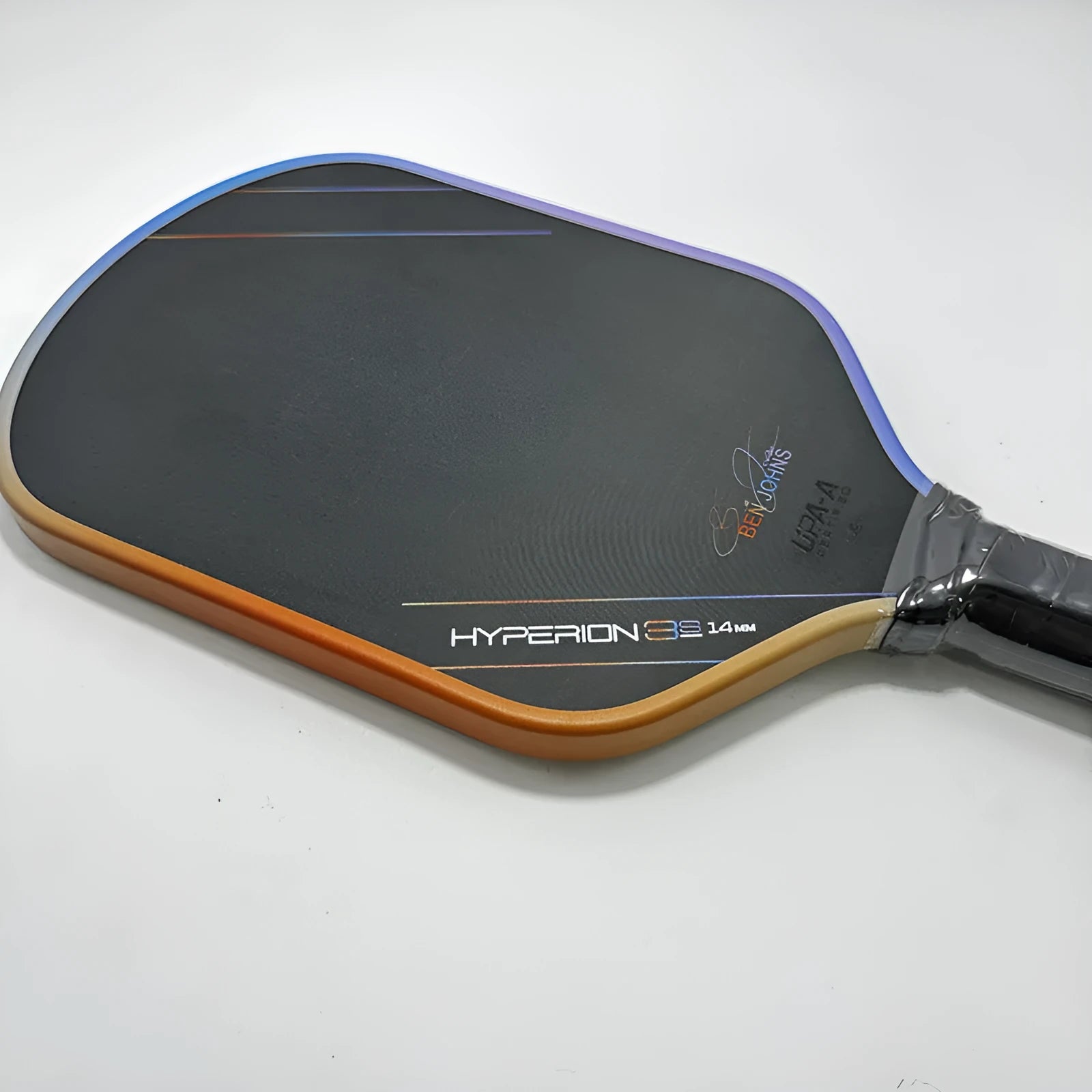 Multicolour matte finish pickleball racket with T700 carbon fibre frame and honeycomb core.