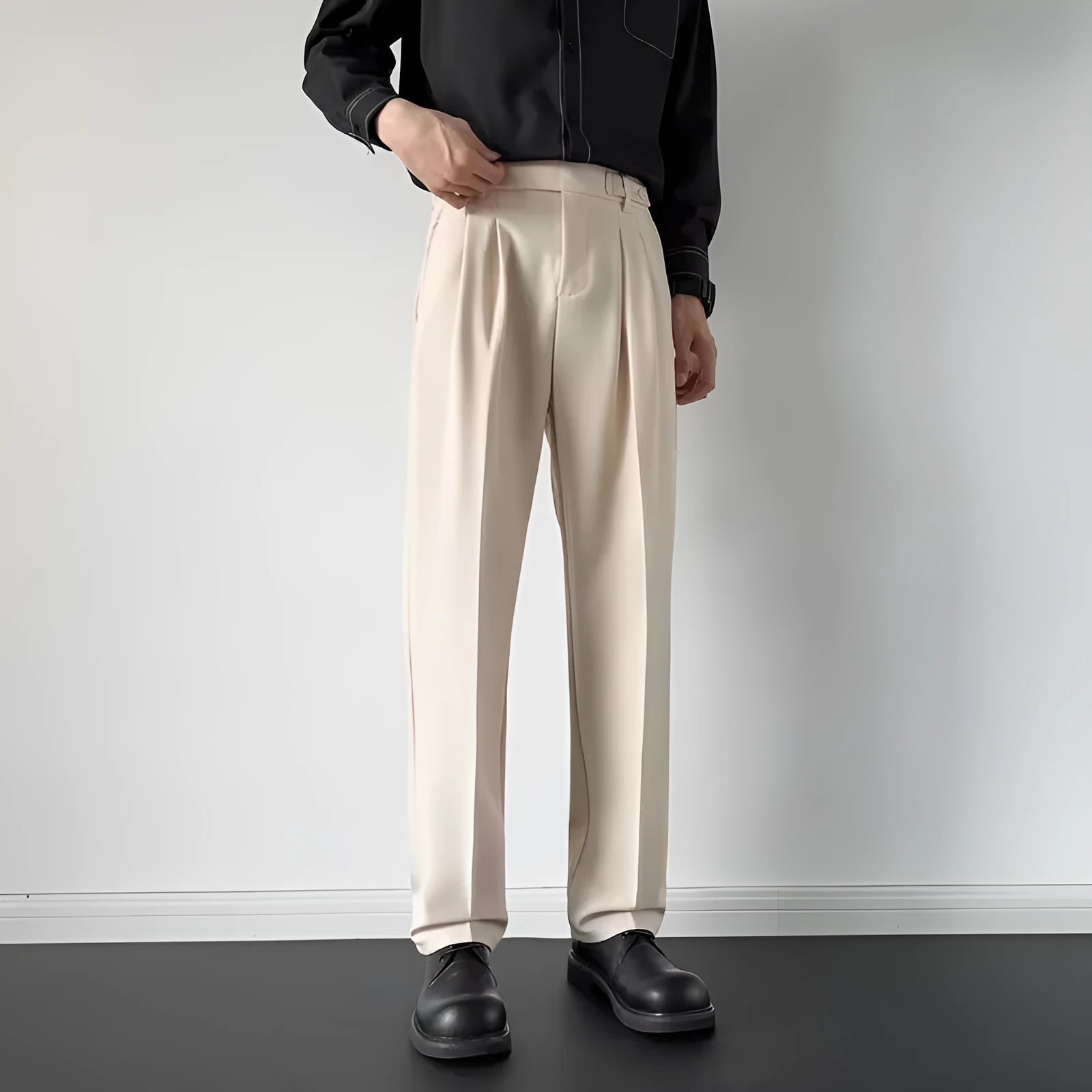 Man wearing straight loose fit suit trousers in apricot colour for formal or office setting