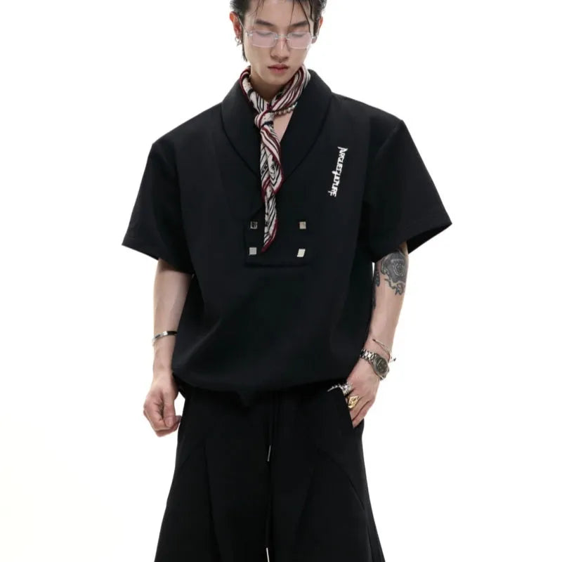 Men's dark grey V-neck sports jacket with padded shoulders and metal details paired with matching shorts