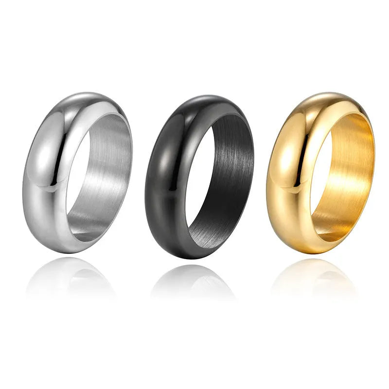 Glossy electroplated titanium steel ring in gold colour on a plain background.