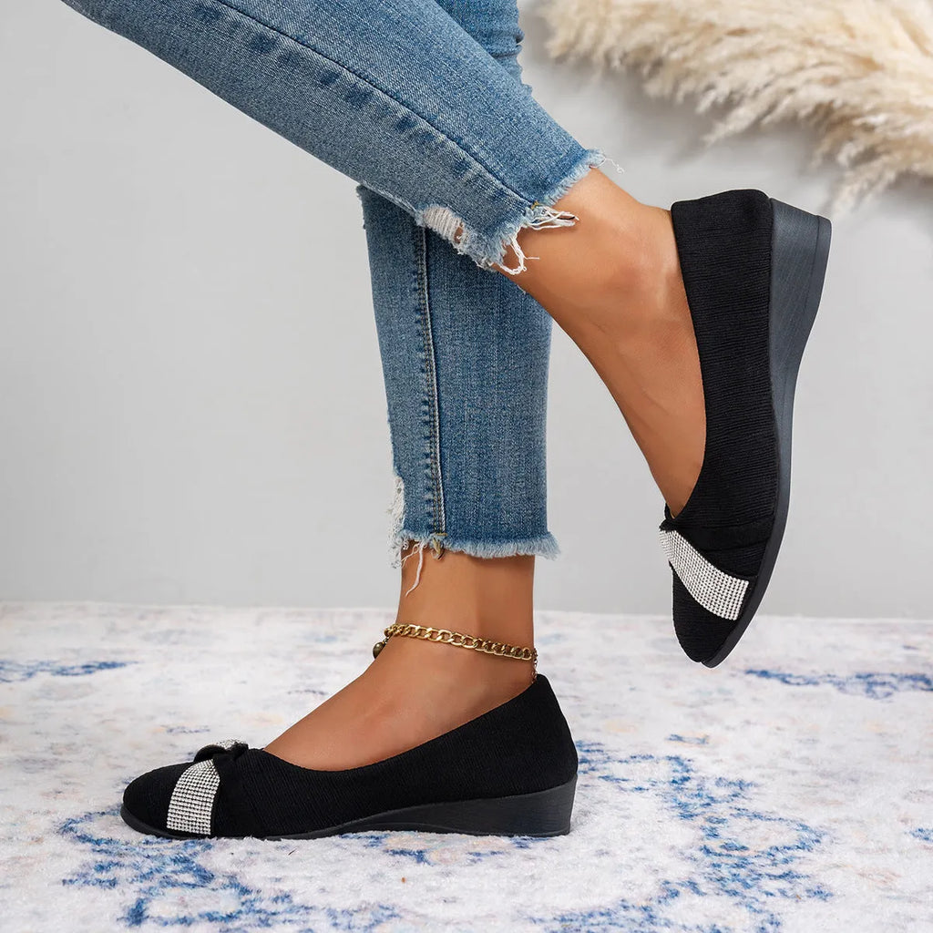 Women's black casual slip-on shoes with rhinestone detail, round toe, and a chunky heel.