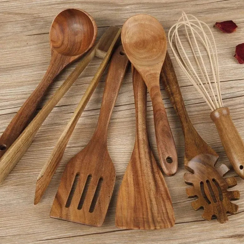 Set of 7 wooden cooking utensils including spoons and shovels arranged on a kitchen surface