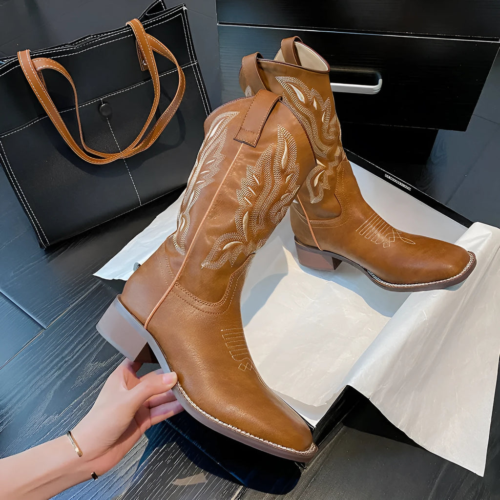 Brown women's embroidered mid-calf Martin boots with leather lining and a square heel.