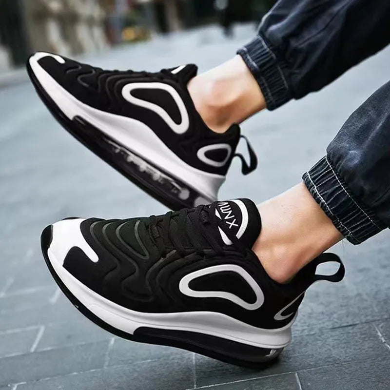 Men's black casual sneakers with lace-up front, thick sole, and round toe for running and outdoor sports.
