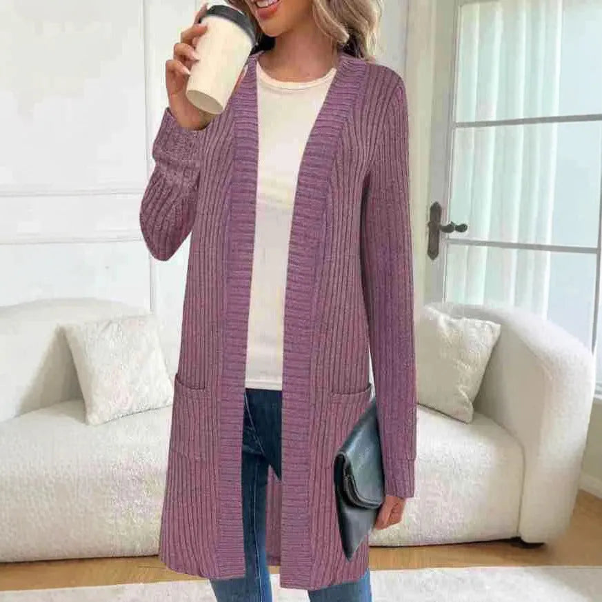 Long sleeve loose pocket knitted cardigan jacket in grey on a hanger.
