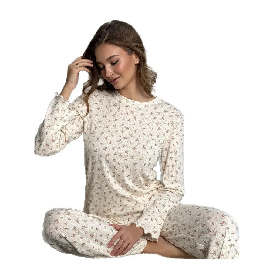 White floral print women's loungewear set with bell sleeve top and wide leg trousers.