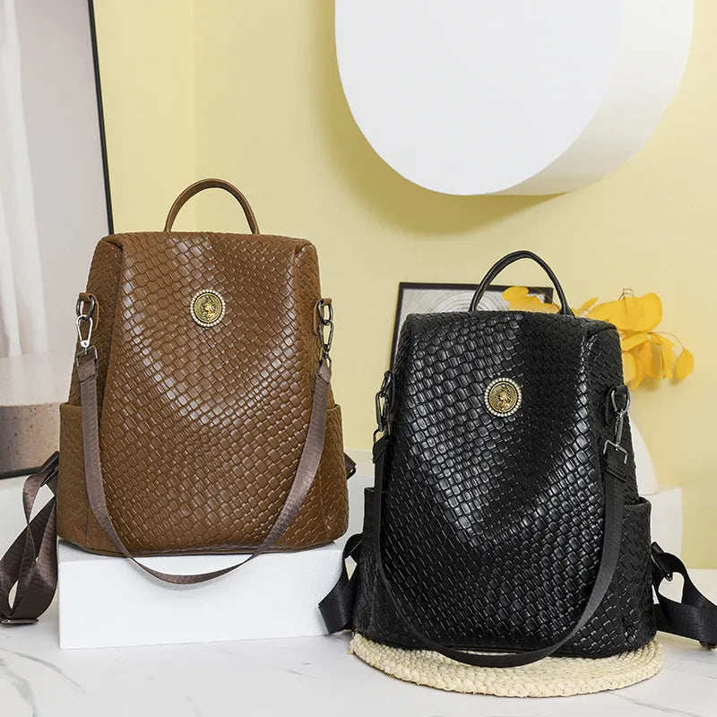 Women's anti-theft backpack with waterproof PU construction showing organisational compartments and urban simplicity styling