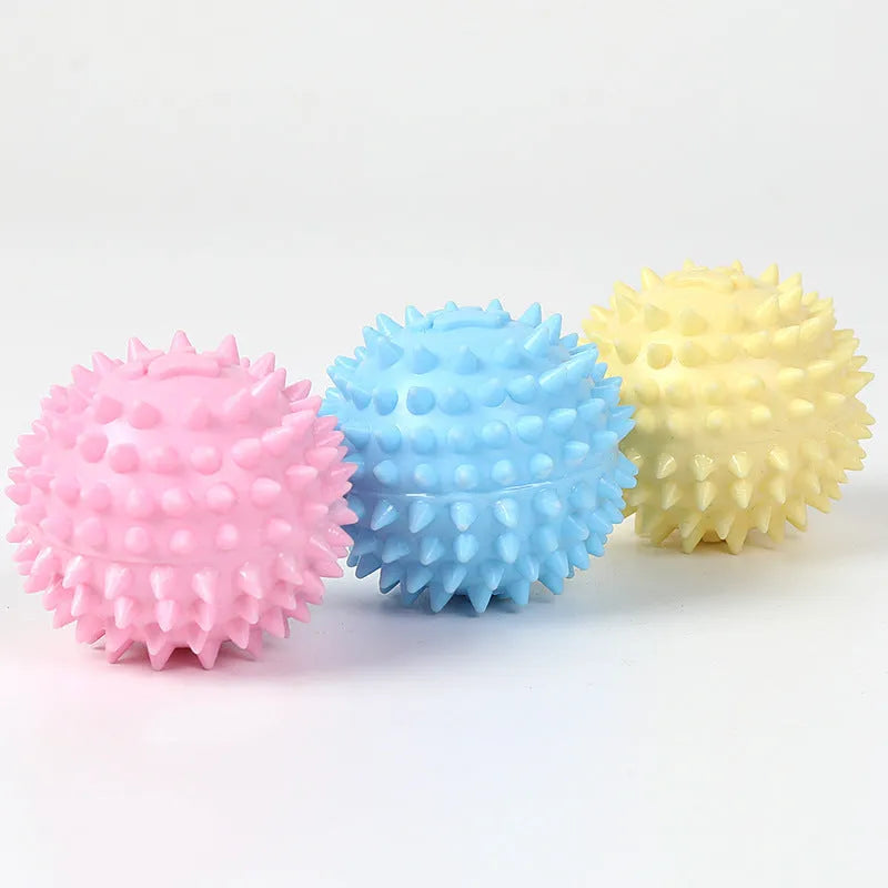 Blue TPR dog chewing ball with footprint design and bulging sides for tooth cleaning.