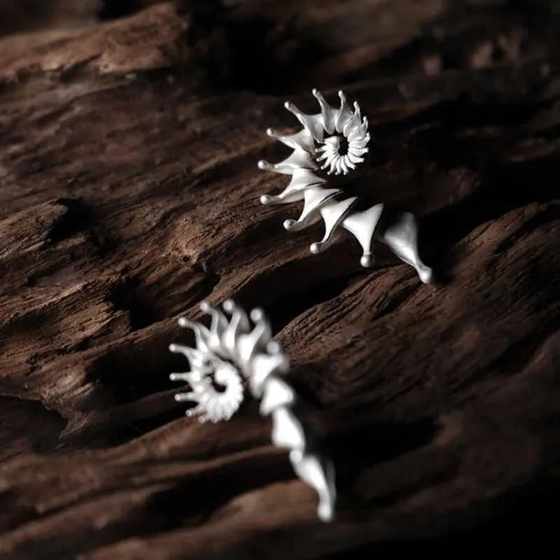 Three-dimensional matte finish conch stud earrings with exaggerated shape and irregular design elements