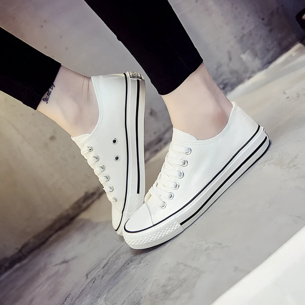 Women's solid colour canvas casual trainers in All Black, shown from the side on a white background.