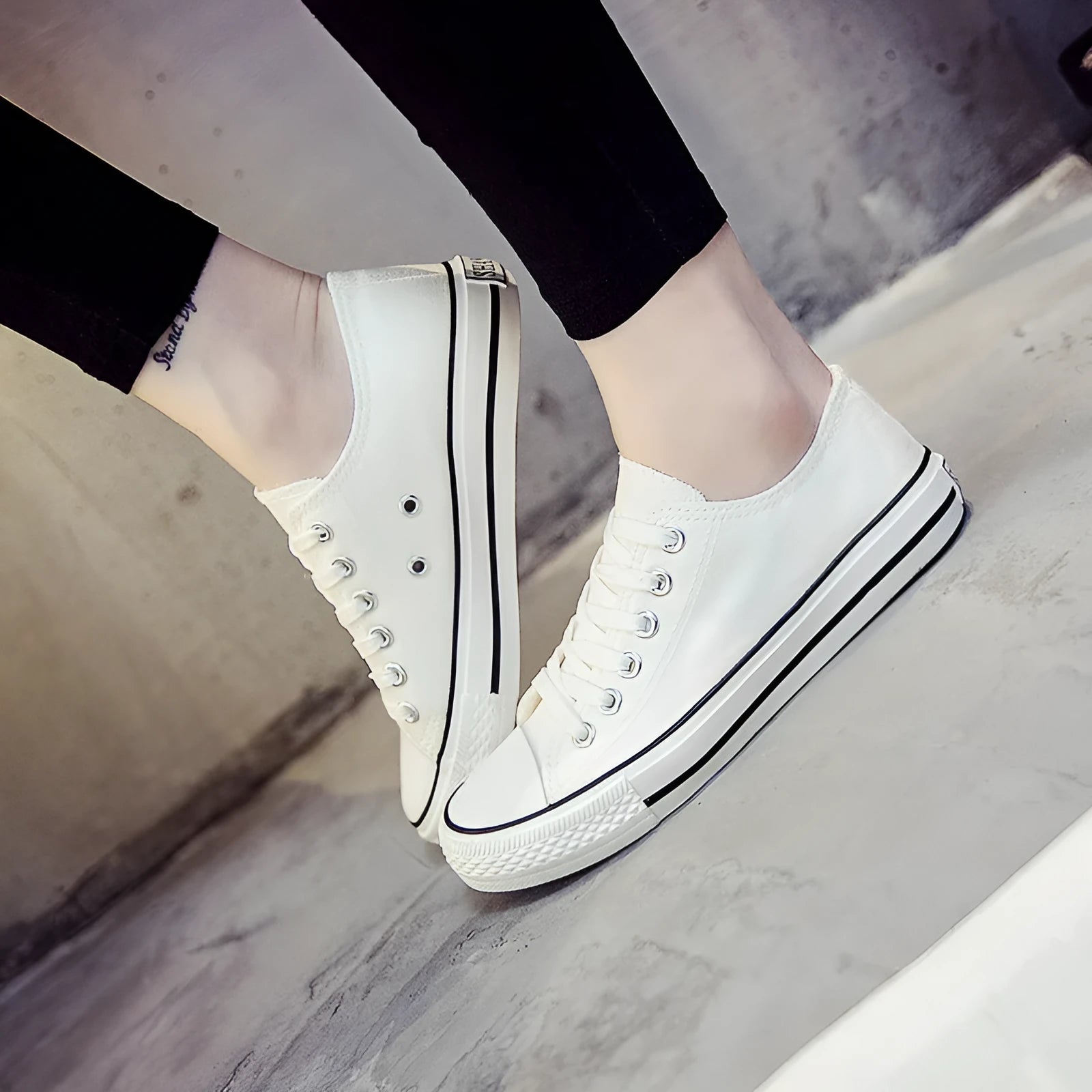Women's solid colour canvas casual trainers in All Black, shown from the side on a white background.
