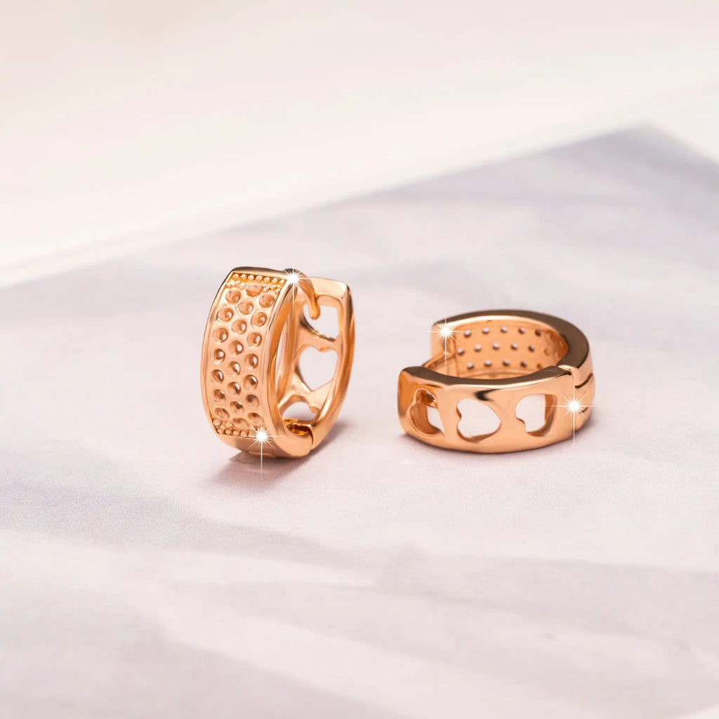 Rose gold electroplated earrings with three hollowed out hearts in circular arrangement