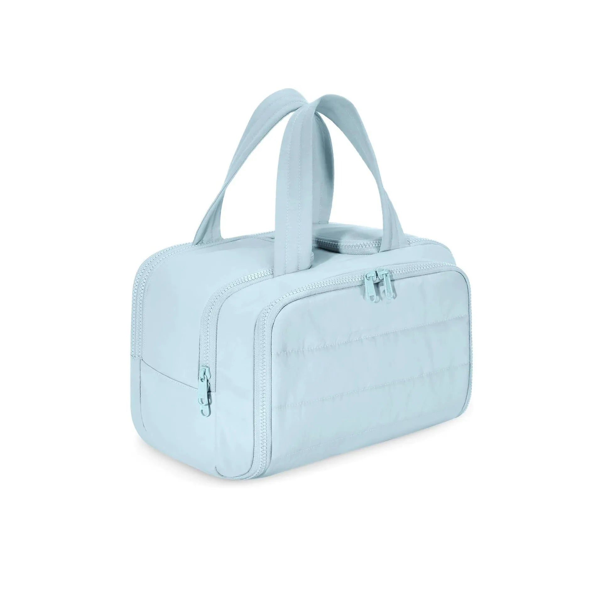 Large beige travel toiletry bag with wide open top, shown next to cosmetic bottles.